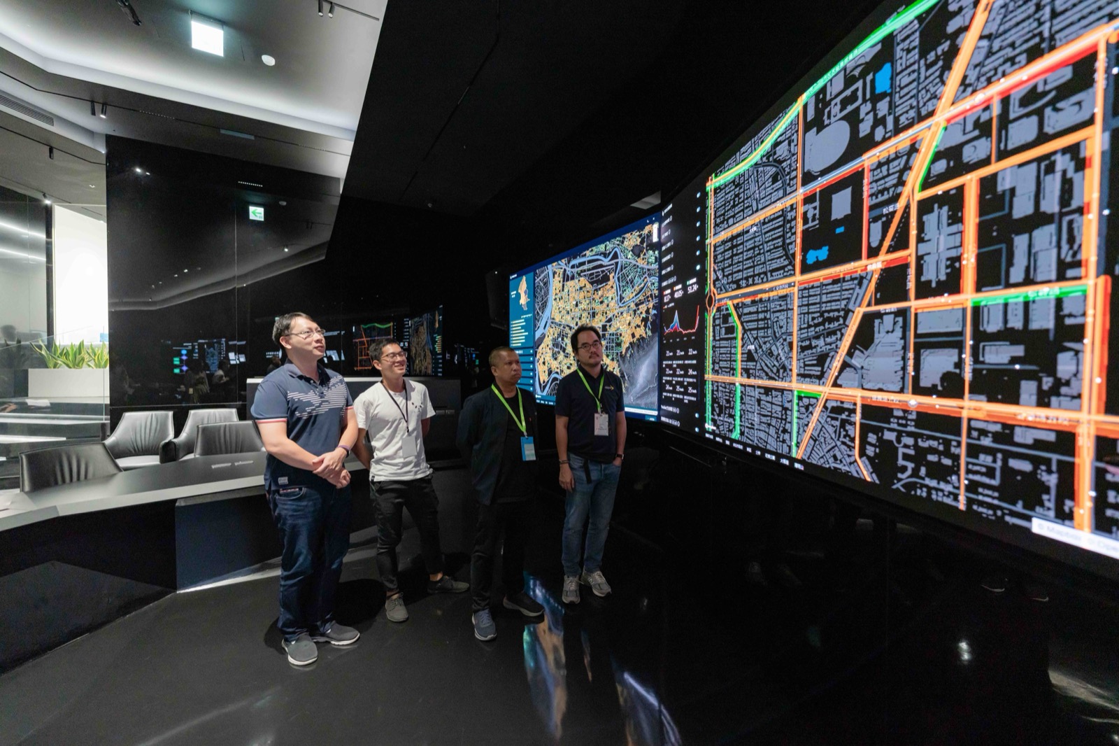 New Taipei City: four people facing a large digital city map on a dark video wall